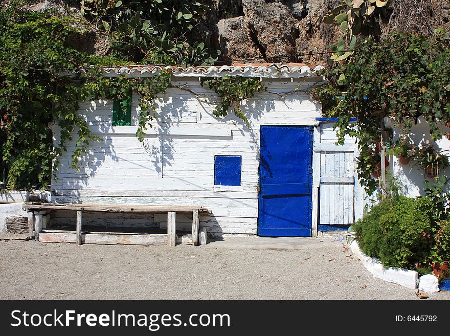 A pretty newly painted beach hut nestling amongst the rocks on the coast of southern Spain. A pretty newly painted beach hut nestling amongst the rocks on the coast of southern Spain.