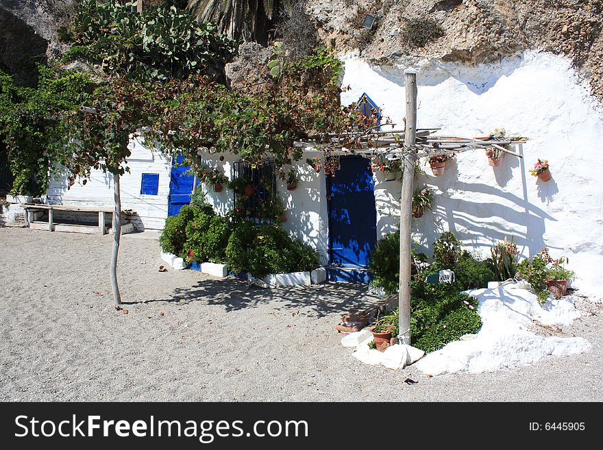 A pretty newly painted beach hut nestling amongst the rocks on the coast of southern Spain. A pretty newly painted beach hut nestling amongst the rocks on the coast of southern Spain.