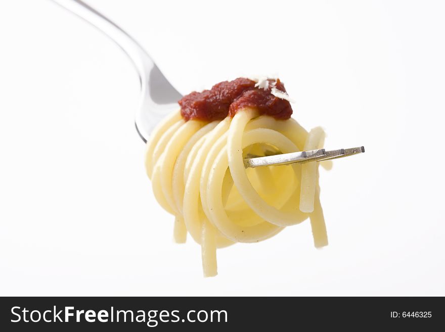 Spaghetti on a fork over white background