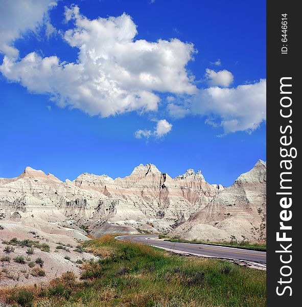 Road through the badlands in South Dakota with a cloudy sky. Road through the badlands in South Dakota with a cloudy sky.