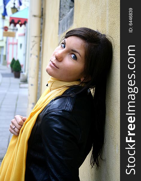 A girl with yellow scarf on the street. A girl with yellow scarf on the street