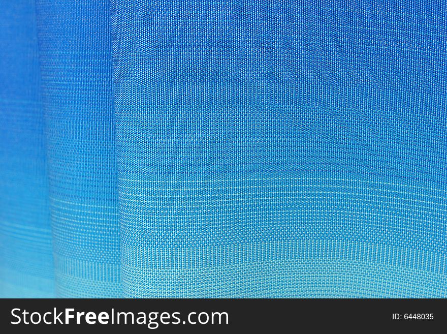 Wavy fabric texture with a gradient from blue to light blue. Wavy fabric texture with a gradient from blue to light blue