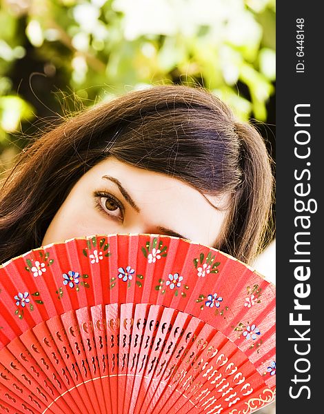 Spanish woman behind traditional fan. Spanish woman behind traditional fan.