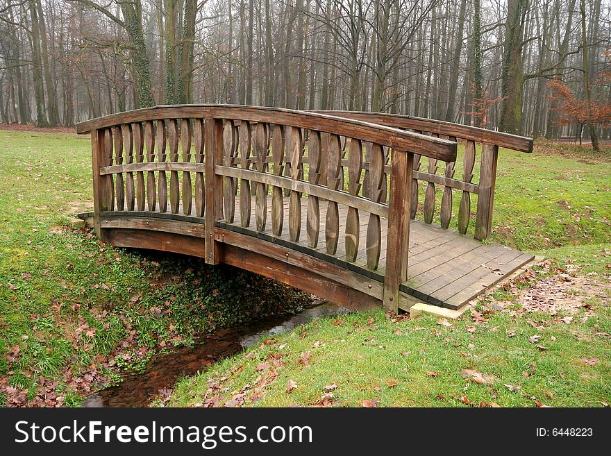 Wooden bridge with creek in autumn