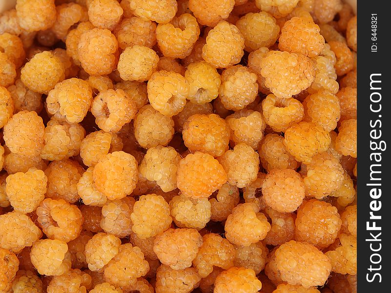 Appetizing yellow raspberry photo background. Appetizing yellow raspberry photo background