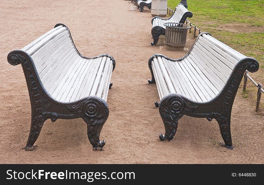 Two park benches standing opposite to each other. Two park benches standing opposite to each other