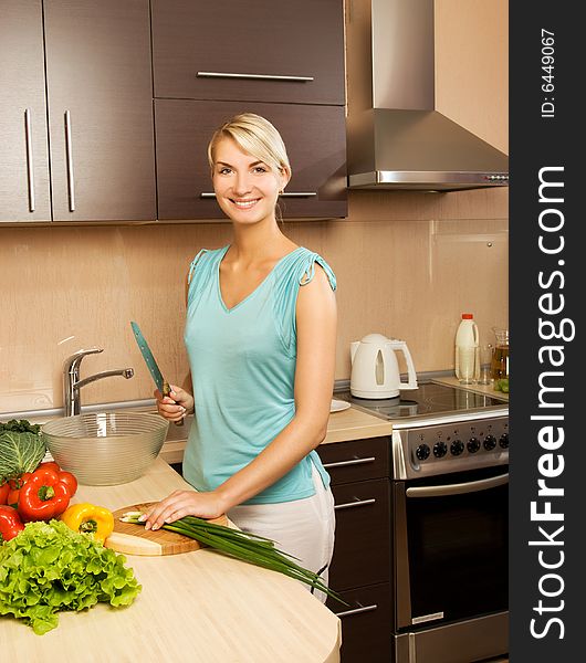 Beautiful young woman making vegetarian vegetable salad. Beautiful young woman making vegetarian vegetable salad