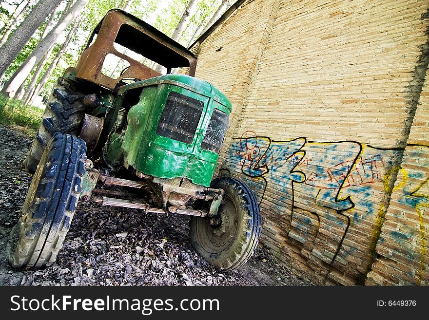 Abandoned tractor close to an old building. Abandoned tractor close to an old building.