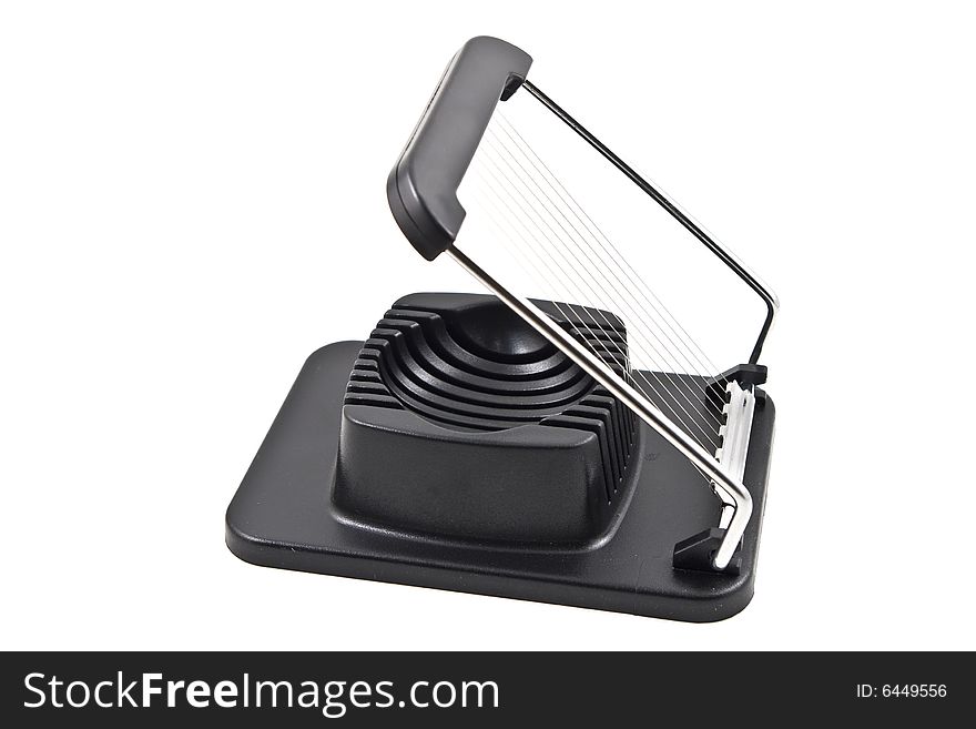 An egg slicer on a white background