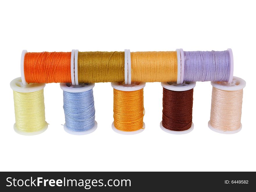 Line of colorful threads isolated on white background