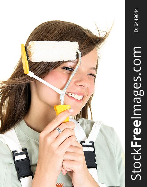 Close-up portrait of a teenager looking at the camera through a paint roller. She is isolated on a white background, space for text is provided on the right side. Close-up portrait of a teenager looking at the camera through a paint roller. She is isolated on a white background, space for text is provided on the right side.