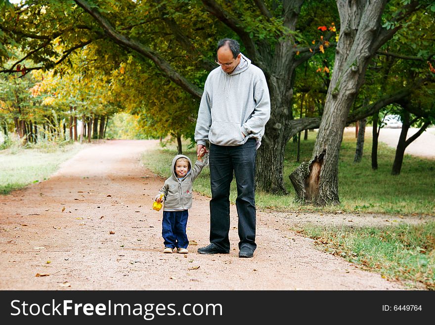 Father and son in autumn park