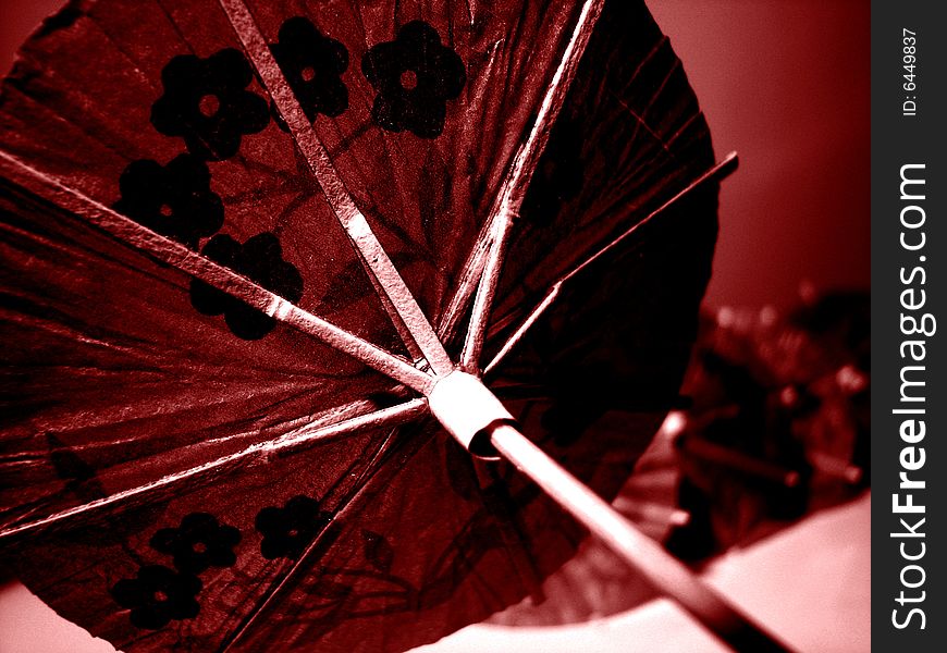 Paper umbrella detail in red for party drinks. Paper umbrella detail in red for party drinks.