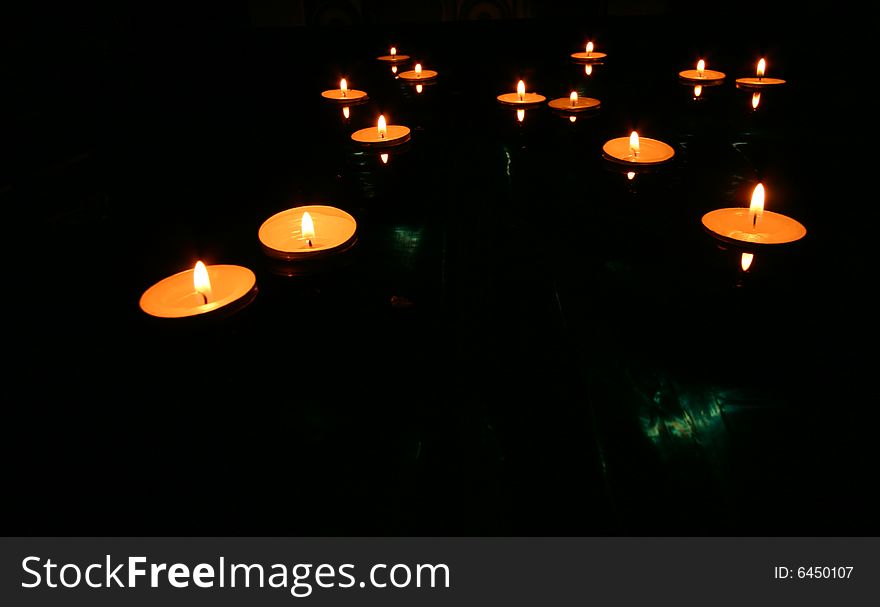 Collection of floating candles on water. Collection of floating candles on water