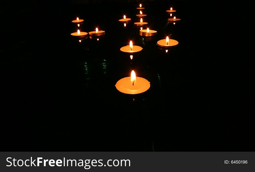 Collection of floating candles on water. Collection of floating candles on water