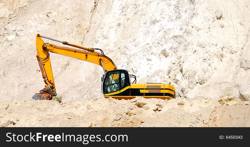 A Large Excavator Working In Sand