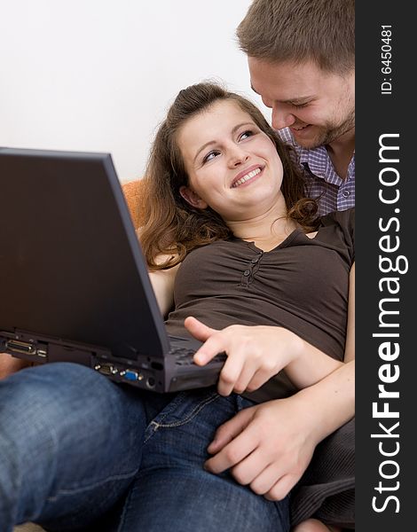 Casual loving couple on sofa with laptop. Casual loving couple on sofa with laptop