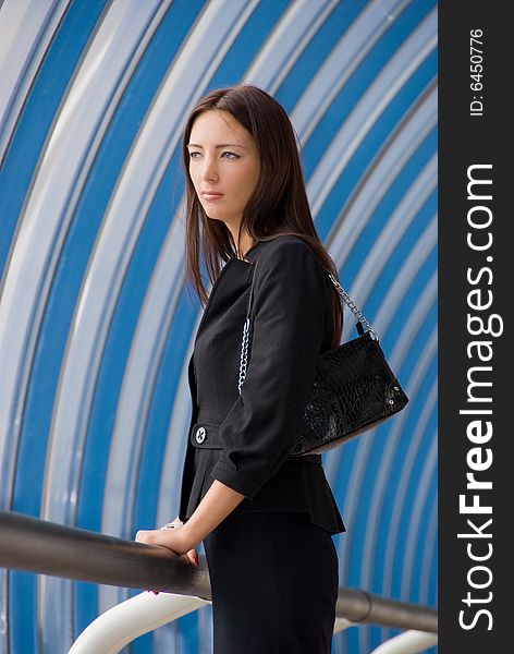 Business woman stands in modern business center