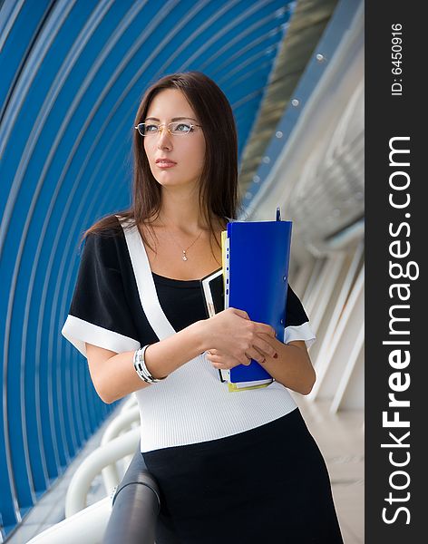 Business woman stands in modern business center