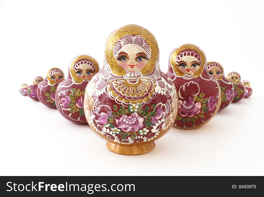 Nine russian dolls in a v- shape on a white background. Nine russian dolls in a v- shape on a white background