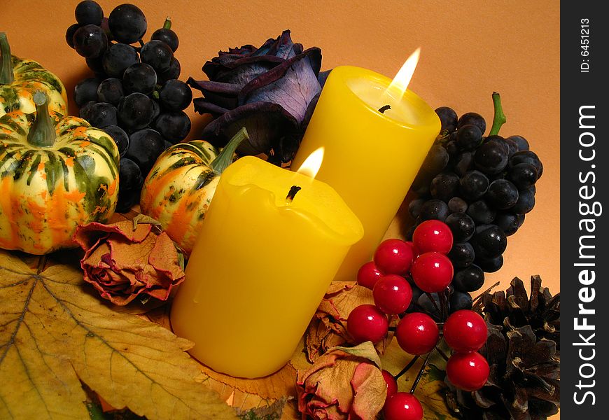 Thanksgiving Day, autumn still life with candles, grapes, leaves and pumpkins