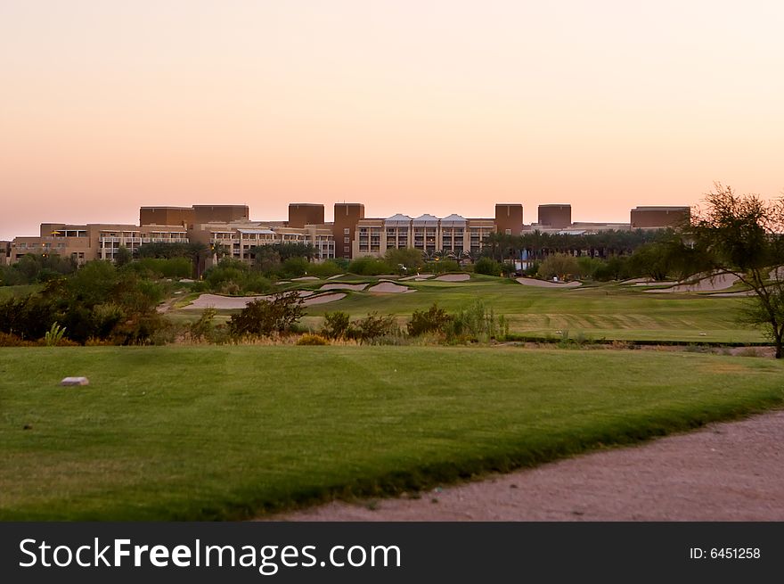 Golf course in the Arizona desert with mountains in the late afternoon sun