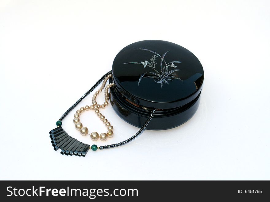 Pearls and pegmatite necklaces in black japan box. Pearls and pegmatite necklaces in black japan box