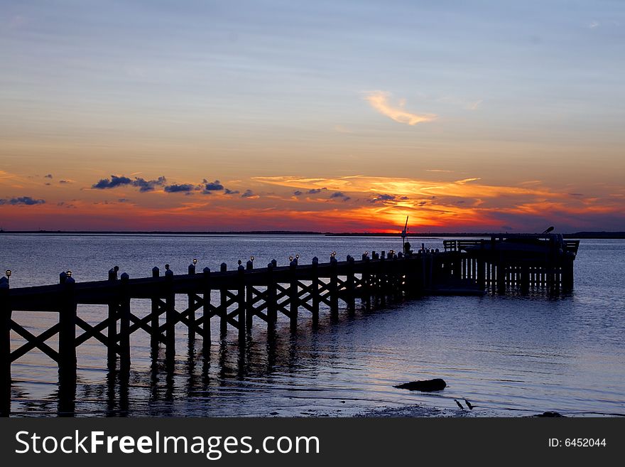 Colorful sun setting over a pier at Long Beach Island. Colorful sun setting over a pier at Long Beach Island