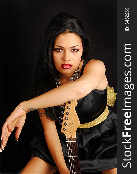 Attractive latino female rocker with her guitar. Attractive latino female rocker with her guitar