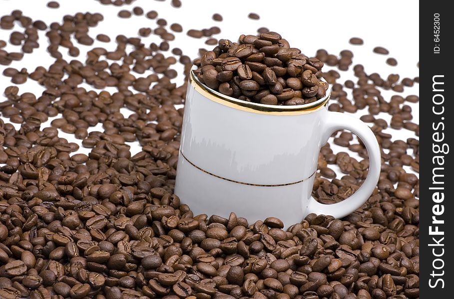 White coffee cup with many coffee beans. White coffee cup with many coffee beans