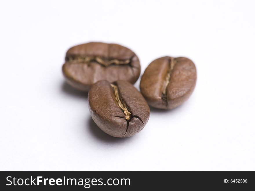 Close up of three coffee beans on white background. Close up of three coffee beans on white background