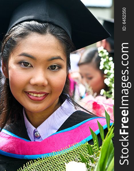 Beautiful Asian university graduates celebrate their success.