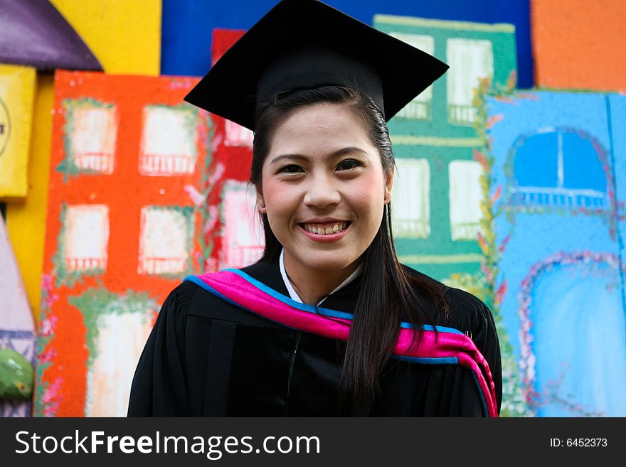 Beautiful Asian university graduates celebrate their success.