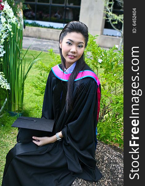 Beautiful Asian university graduates celebrate their success.