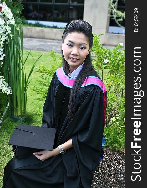 Beautiful Asian university graduates celebrate their success.