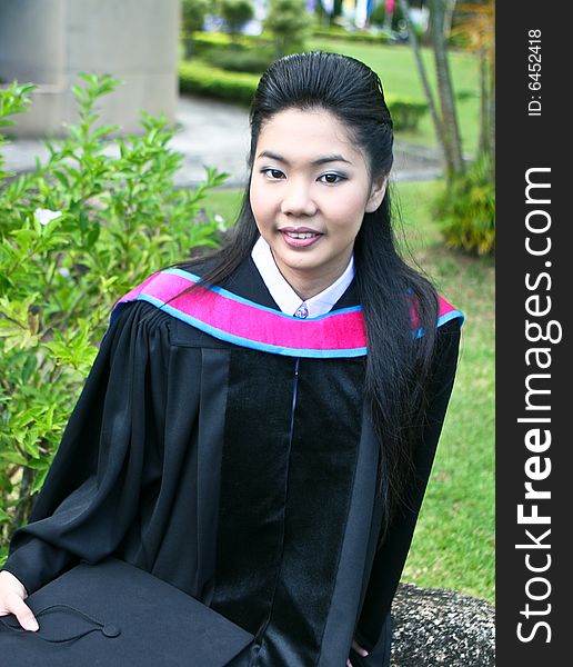 Beautiful Asian university graduates celebrate their success.