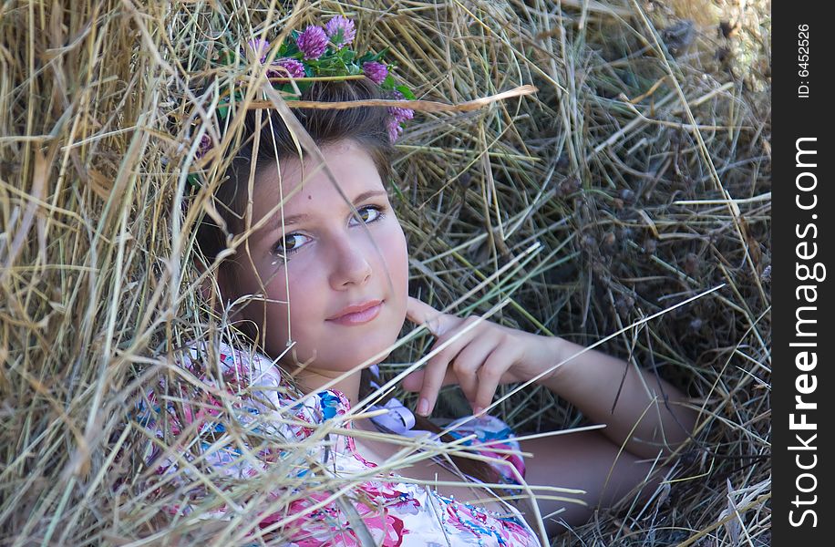 Portrait of the young girl having a rest on the nature, in summer day.