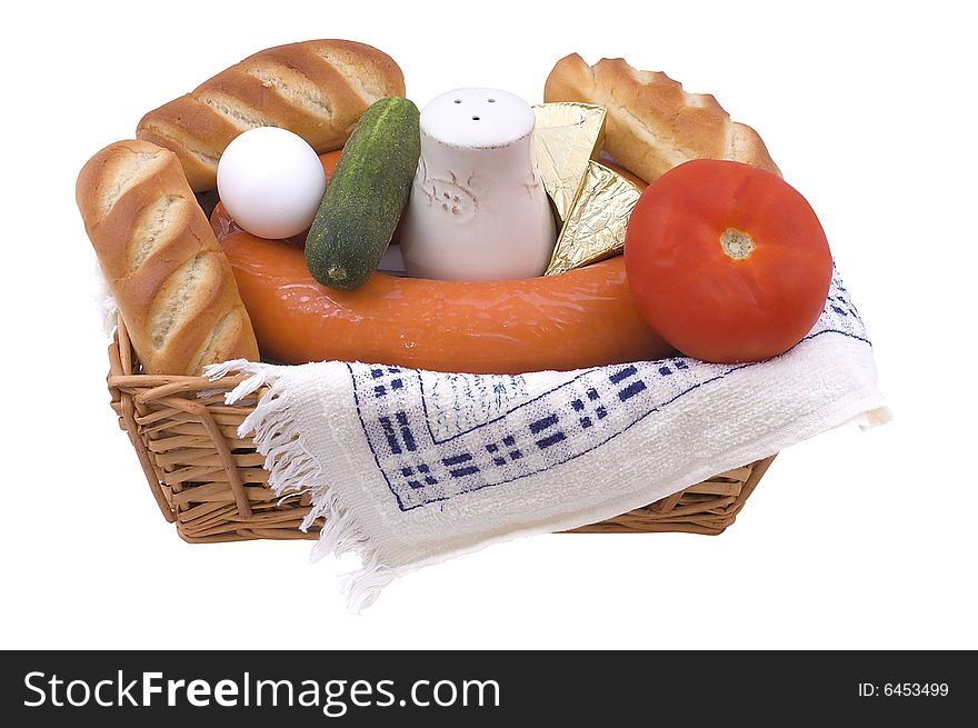 Wattled basket with bread, tomato, cucumber, egg and saltcellar. Isolated on white. Wattled basket with bread, tomato, cucumber, egg and saltcellar. Isolated on white.