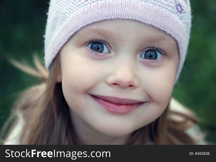 Little girl in a lilac hat