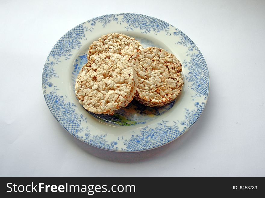 Crackers on porcelan plate on white background. Crackers on porcelan plate on white background