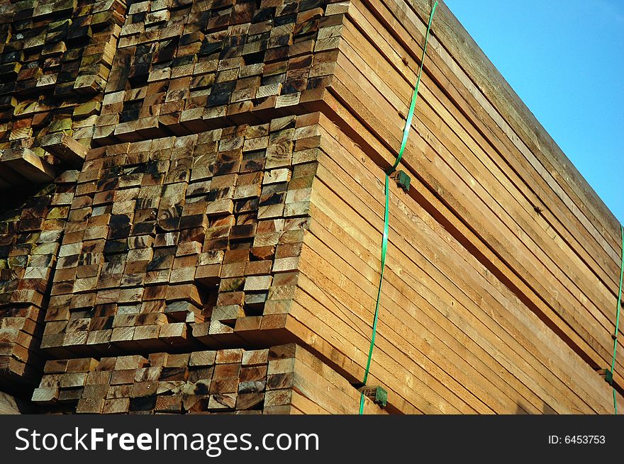 Pile of wood in the afternoon sun on the construction site