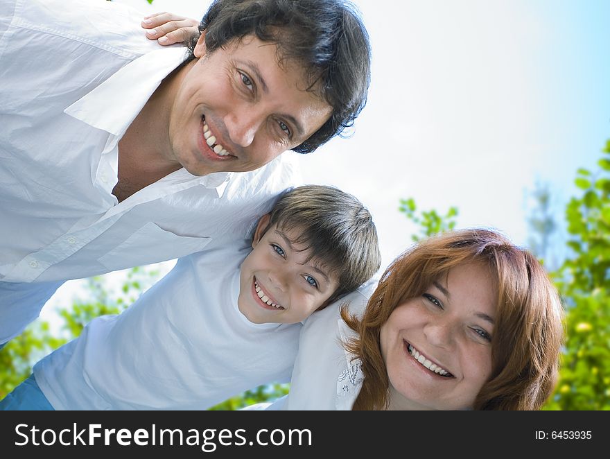 Portrait of young happy family in summer environment. Portrait of young happy family in summer environment