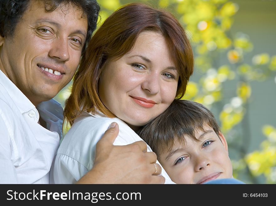 Portrait of young happy family in summer environment. Portrait of young happy family in summer environment