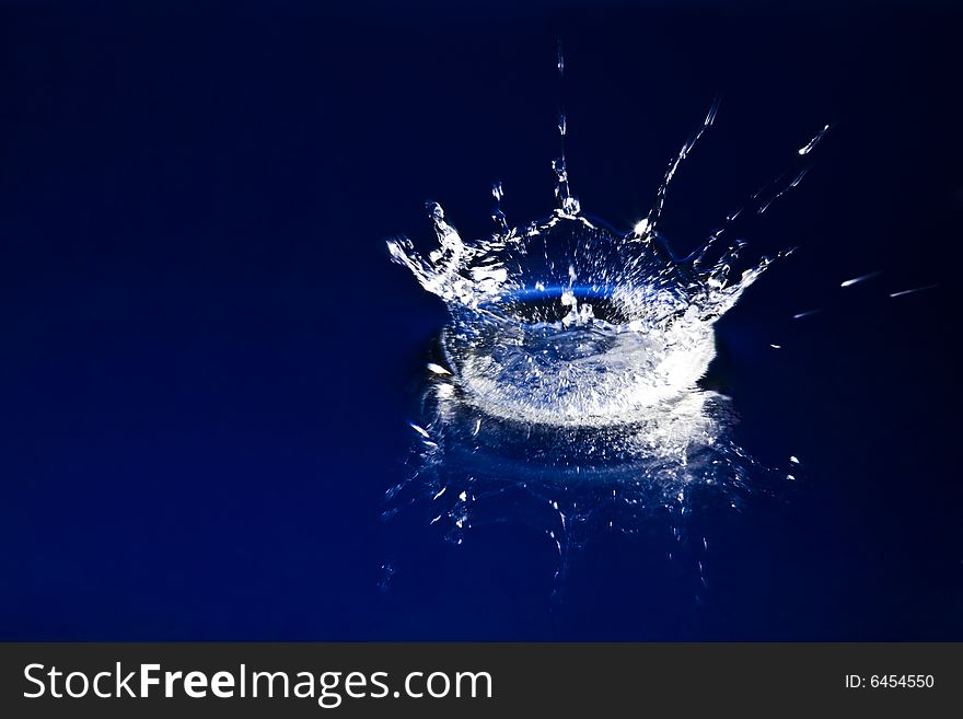 Sparks of deep blue water on black background. Sparks of deep blue water on black background