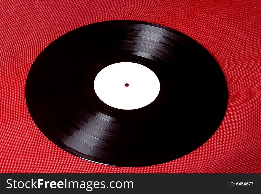 Vinyl record with white label on red ground