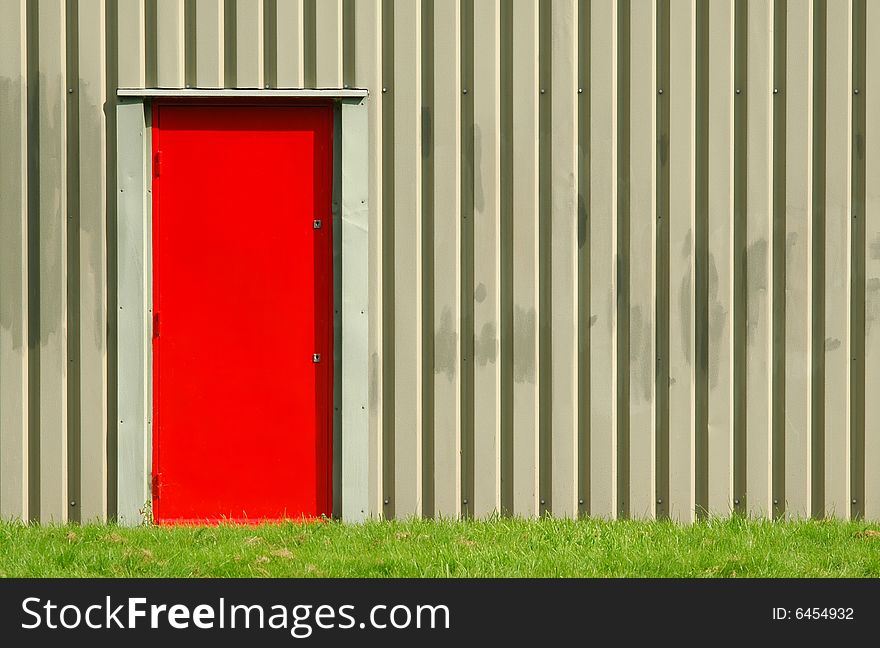 Red fire door exit on a warehouse exterior. Red fire door exit on a warehouse exterior