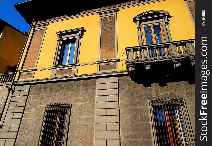 A good shot of a building's facade and a balcony. A good shot of a building's facade and a balcony