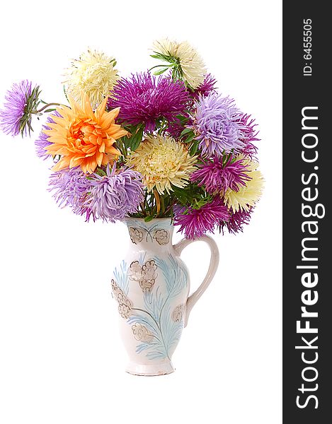 Bunch of colorful asters in old vase isolated on white background