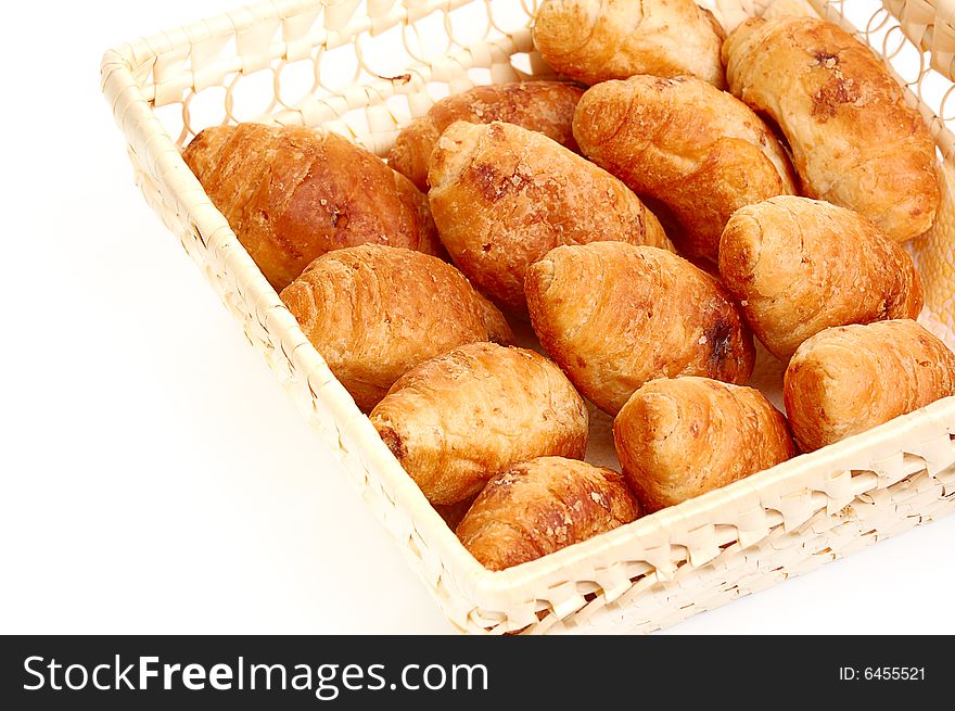 Croissants in basket isolated on white background. Croissants in basket isolated on white background