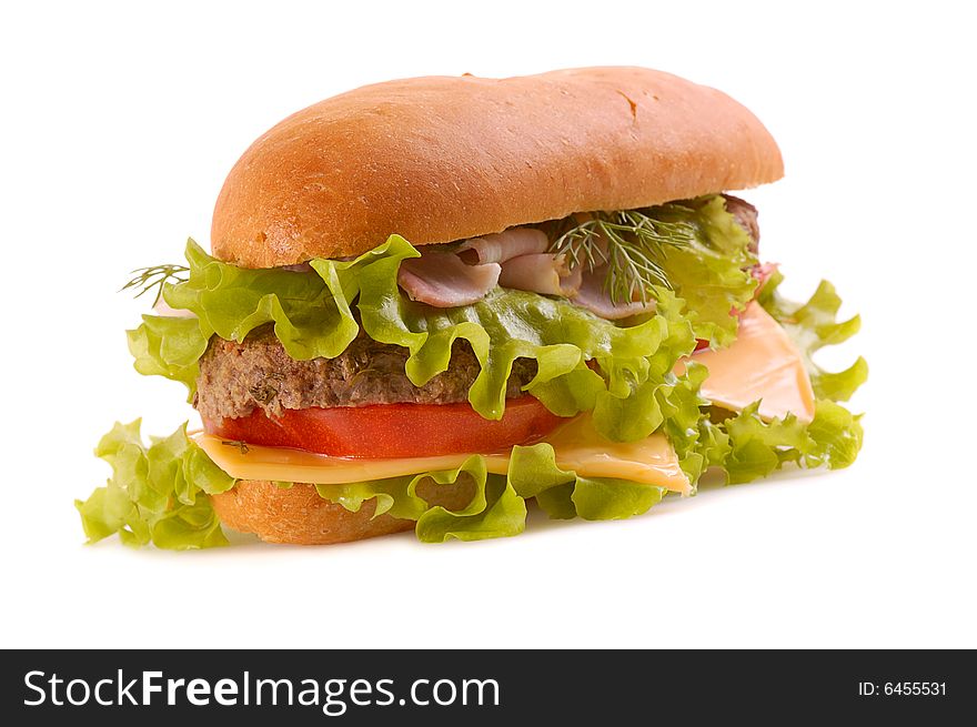 Big hamburger with slices of cheese, lettuce, bacon, beef,tomato, drill